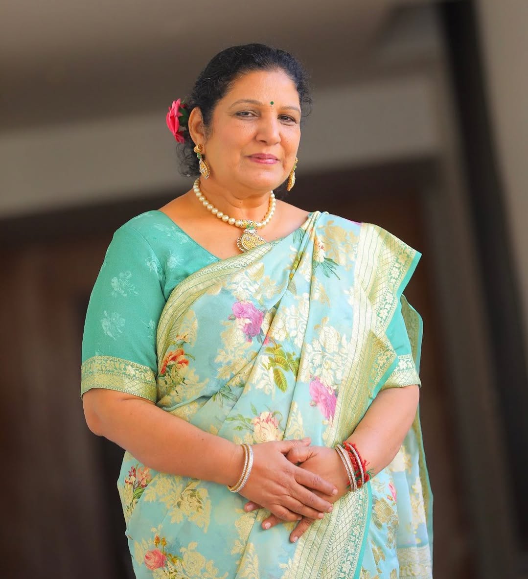 Bhargavi's mother wearing a floral turquoise sari